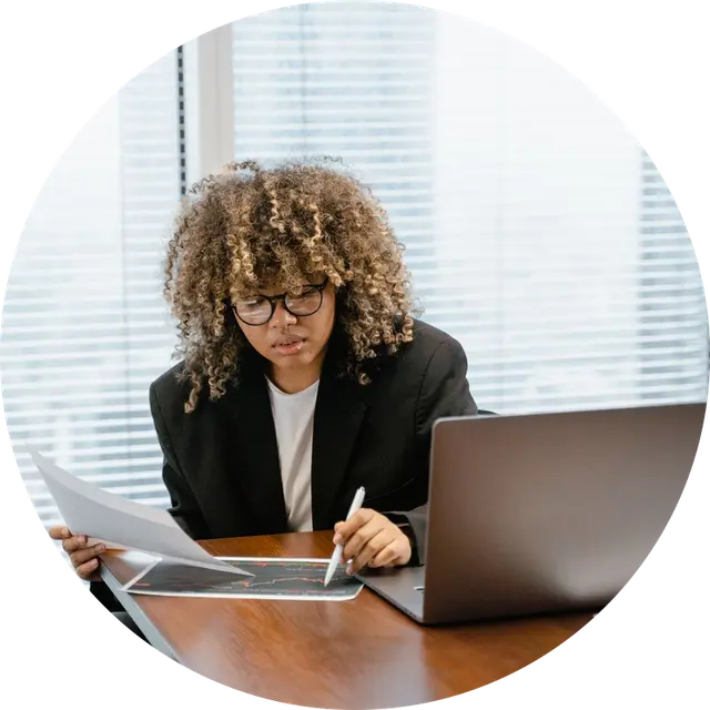Analyst reviewing structured research data and charts